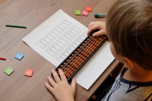 Child practicing abacus for mental math development