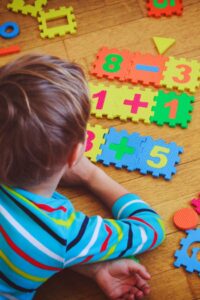 Young child solving math puzzles with brain development concept illustration