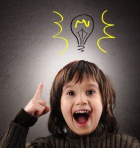 Excited child pointing upward with glowing light bulb illustration above head symbolizing smart thinking and confidence.