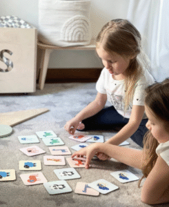 Children using educational flashcards during an interactive learning activity.