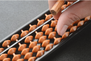 Child using an abacus to improve mental math, concentration, and number sense skills.